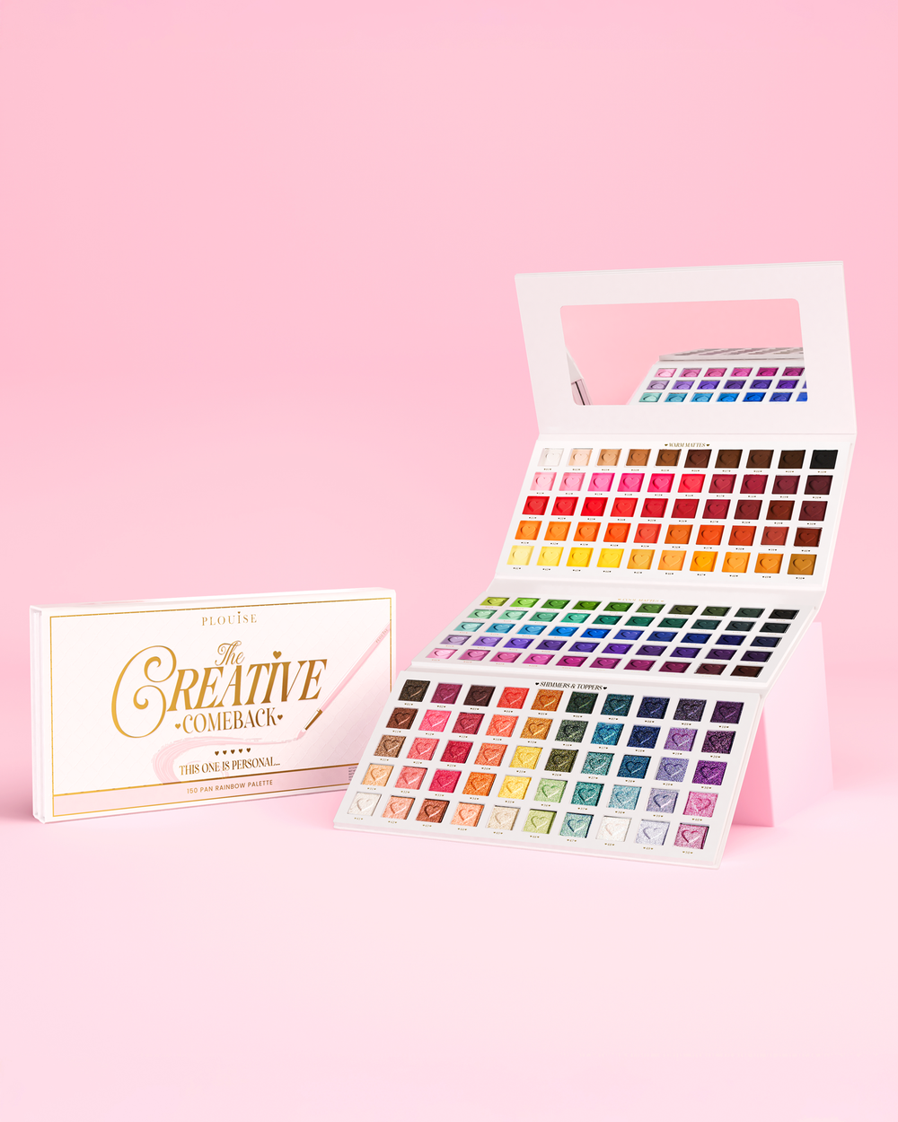 Open P.Louise Creative Comeback XXXL Rainbow Eyeshadow Palette against a pink background with the pink packaging box next to it