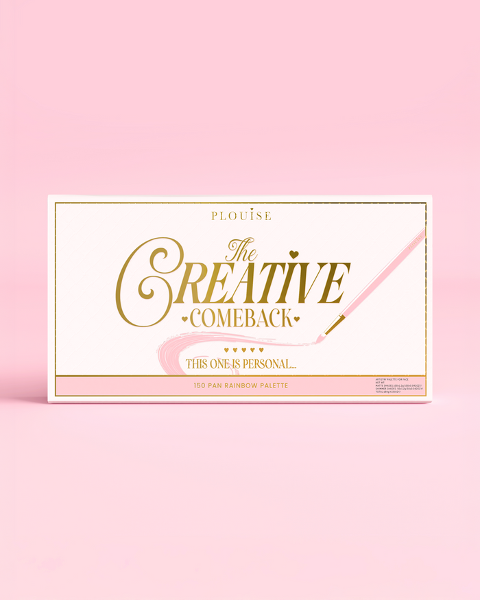 The front of a closed P.Louise Creative COmeback XXXL Rainbow Eyeshadow Palette with gold typography on a pink case against a pink background